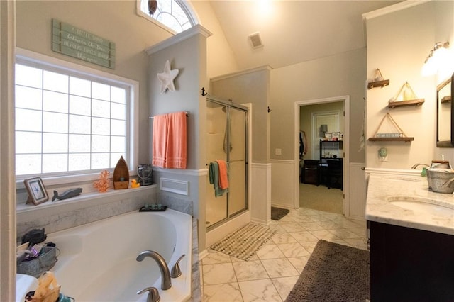 bathroom featuring plus walk in shower, vanity, and lofted ceiling