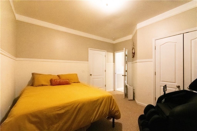 carpeted bedroom with crown molding, a closet, and radiator heating unit