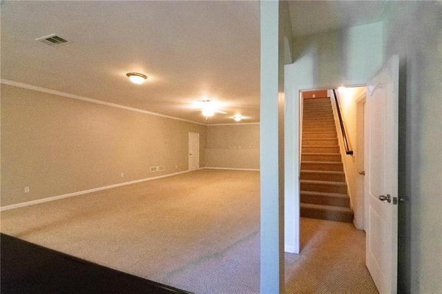 basement featuring carpet floors and ornamental molding