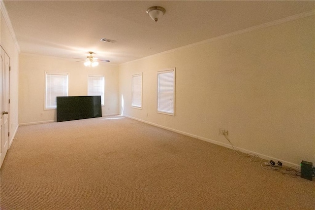 carpeted spare room featuring ornamental molding and ceiling fan