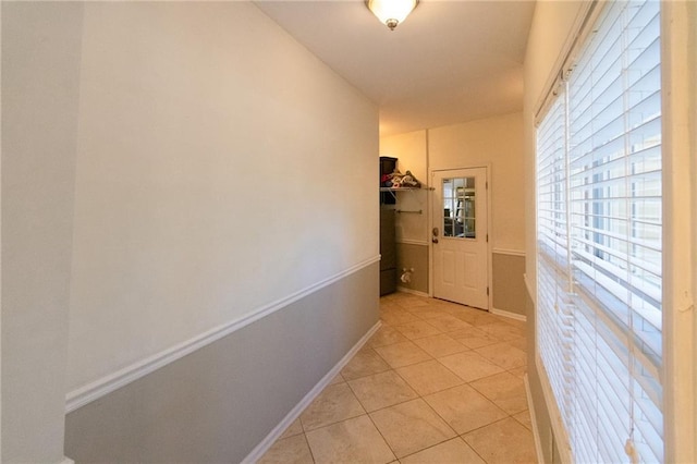 hall with light tile patterned floors