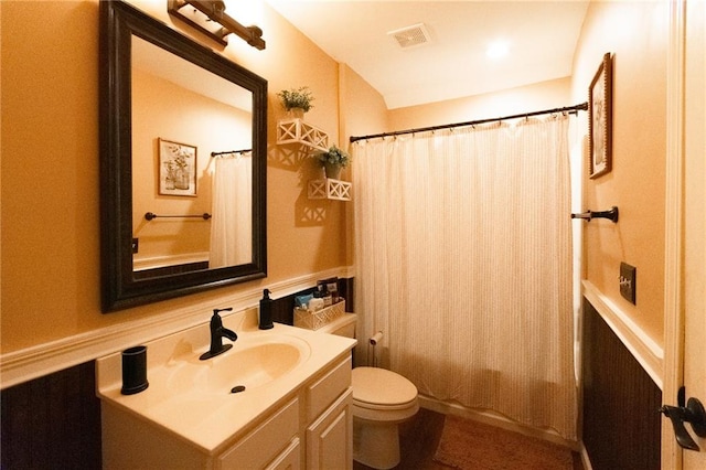 full bathroom with toilet, shower / tub combo with curtain, and vanity