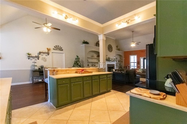 kitchen with ceiling fan, crown molding, freestanding refrigerator, open floor plan, and green cabinetry