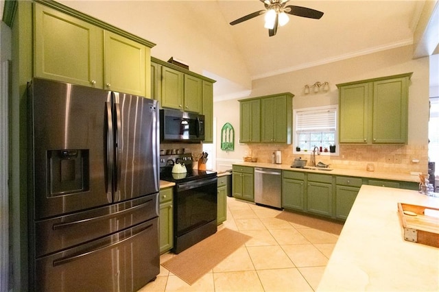 kitchen featuring appliances with stainless steel finishes, light tile patterned flooring, sink, and green cabinetry