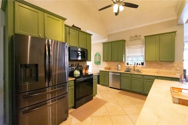 kitchen featuring a sink, appliances with stainless steel finishes, green cabinetry, and light countertops