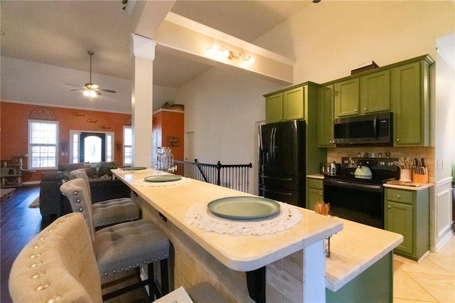 kitchen with ceiling fan, light countertops, green cabinetry, tasteful backsplash, and black appliances