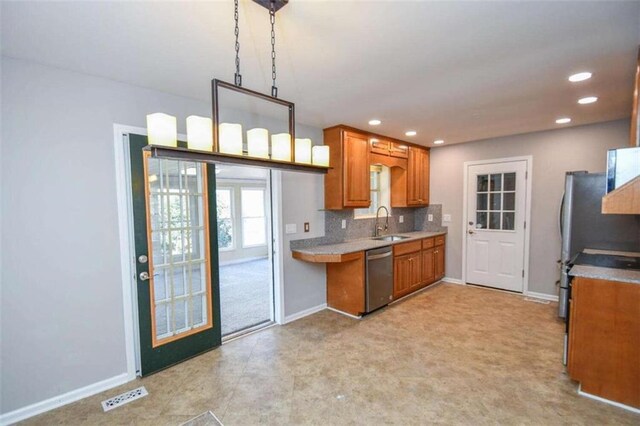 kitchen featuring light stone countertops, sink, appliances with stainless steel finishes, and tasteful backsplash