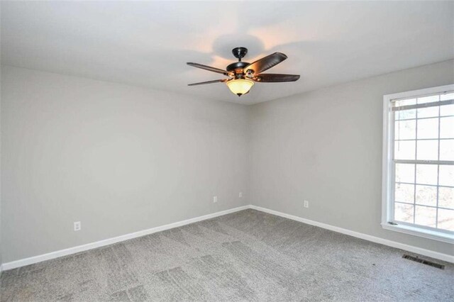 unfurnished bedroom featuring ceiling fan, ensuite bathroom, and light carpet