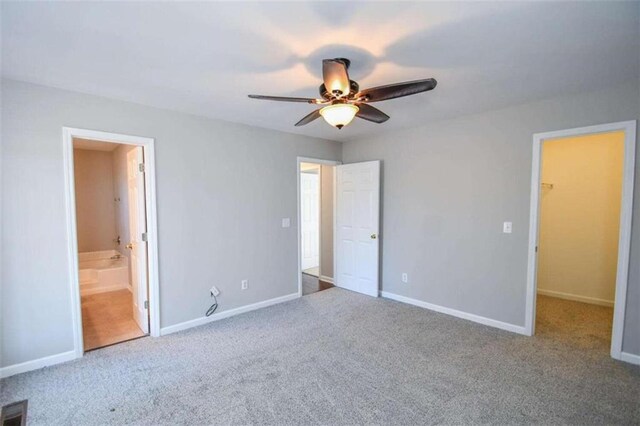 spare room featuring carpet floors and ceiling fan