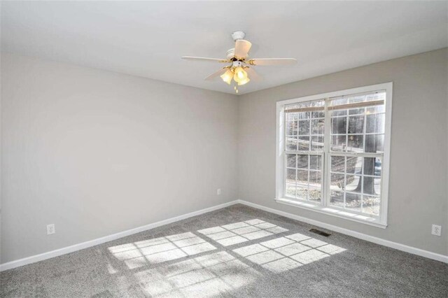 unfurnished room with ceiling fan and carpet flooring