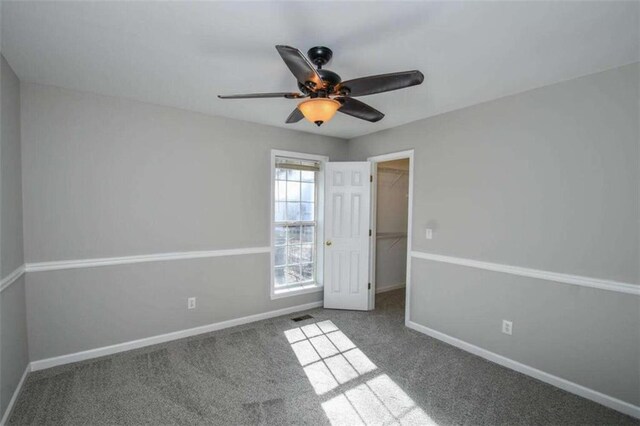 spare room with light carpet and ceiling fan