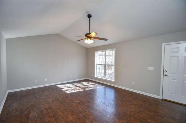 spare room featuring ceiling fan, lofted ceiling, and dark hardwood / wood-style floors