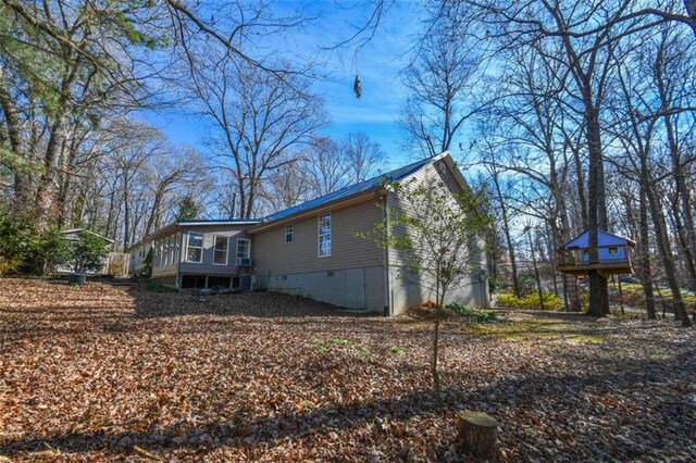 view of side of property featuring a sunroom