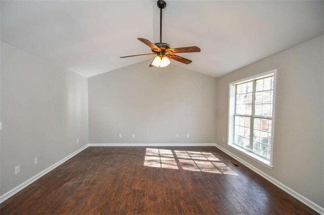 unfurnished living room featuring vaulted ceiling, ceiling fan, dark hardwood / wood-style flooring, and french doors