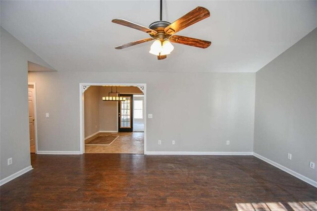 spare room featuring ceiling fan, dark hardwood / wood-style flooring, and lofted ceiling