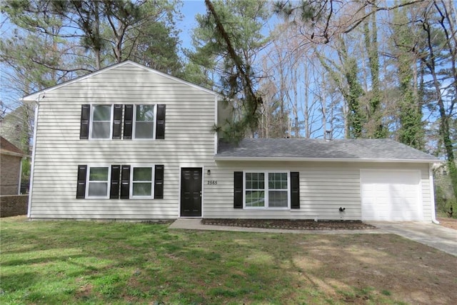 view of front of property with a garage and a front yard