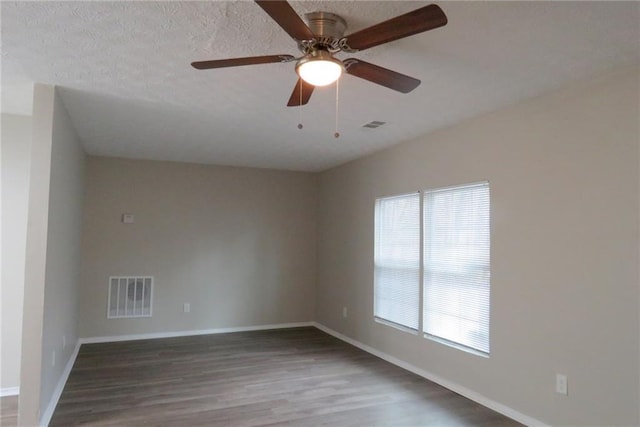 empty room featuring ceiling fan, wood-type flooring, and a textured ceiling