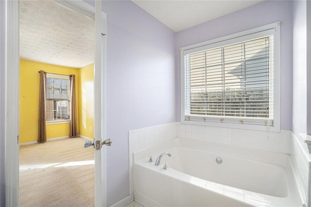 bathroom with a bathtub and a textured ceiling