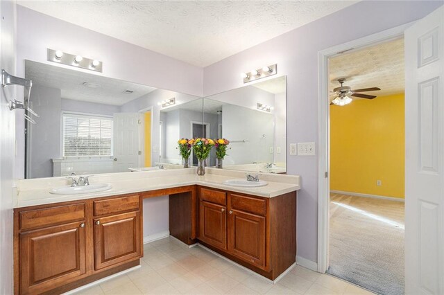 bathroom featuring ceiling fan, a textured ceiling, and vanity