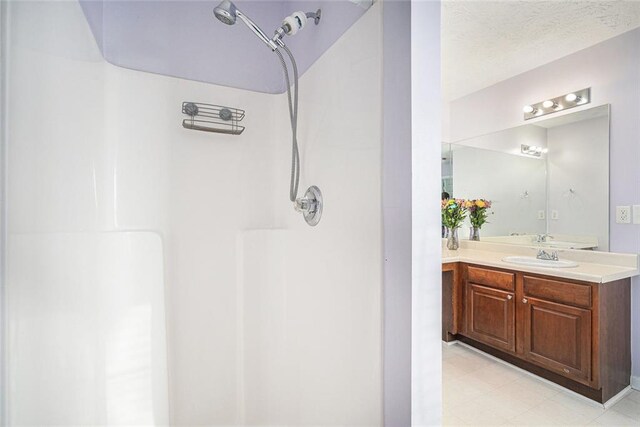 laundry area with electric dryer hookup, dark hardwood / wood-style flooring, hookup for a washing machine, and a textured ceiling