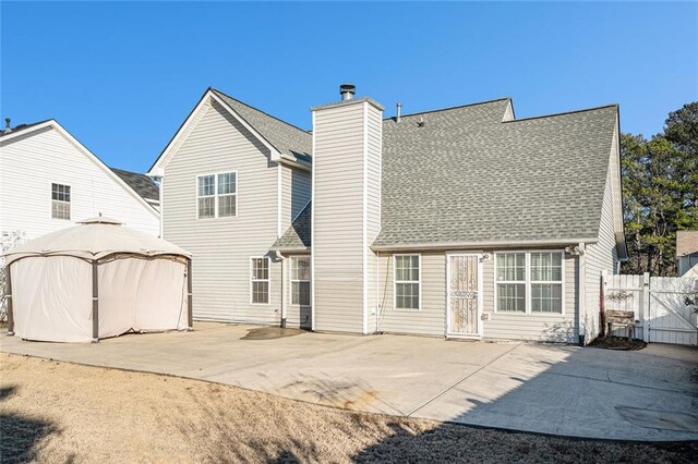 rear view of property with a gazebo and a patio