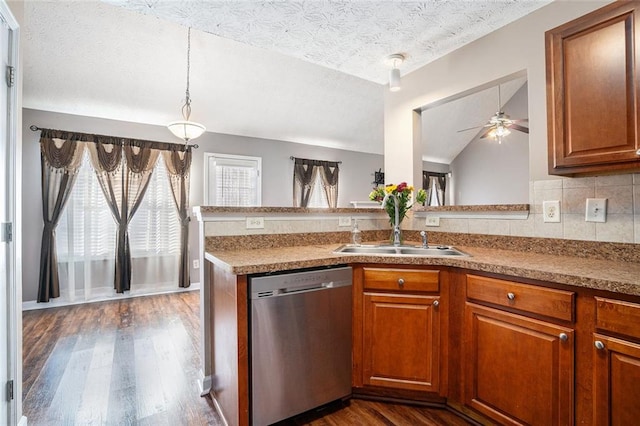 kitchen featuring kitchen peninsula, stainless steel dishwasher, a textured ceiling, vaulted ceiling, and ceiling fan