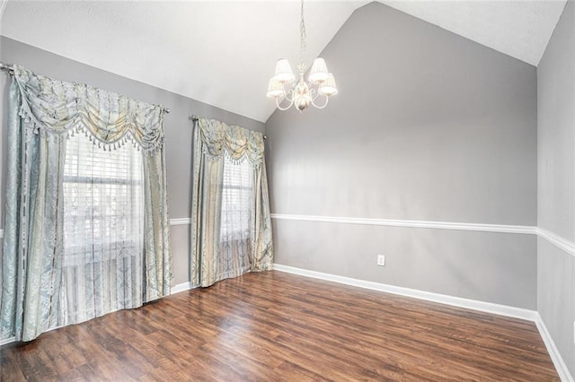 spare room featuring vaulted ceiling, a chandelier, and dark hardwood / wood-style flooring