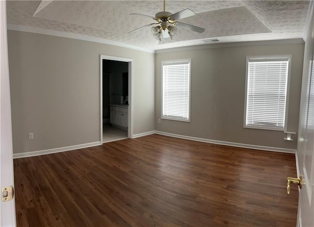 802 Village Pl, Loganville, GA 30052 - unfurnished bedroom with dark wood-style flooring, baseboards, a textured ceiling, ensuite bathroom, and crown molding