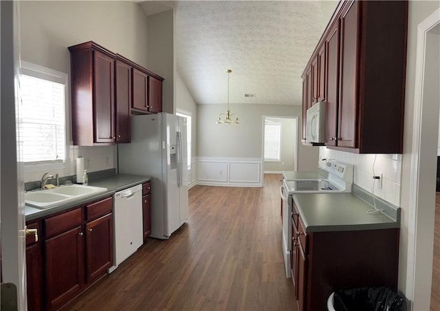 802 Village Pl, Loganville, GA 30052 - kitchen with white appliances, a sink, dark brown cabinets, a textured ceiling, and dark wood-type flooring