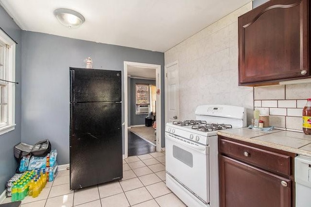 kitchen featuring tasteful backsplash, cooling unit, white appliances, and light tile patterned floors