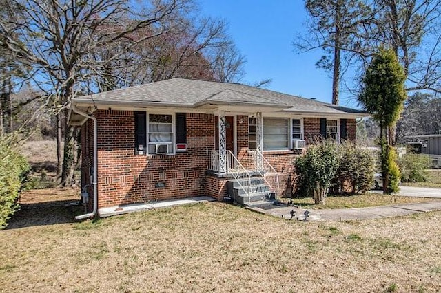 bungalow-style home featuring a front yard, crawl space, and brick siding