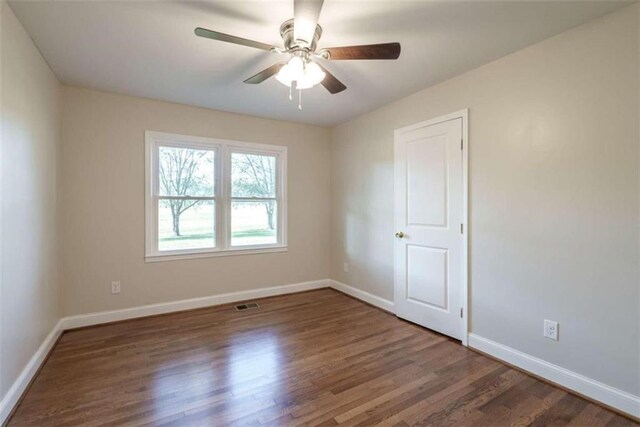 spare room with ceiling fan and dark hardwood / wood-style floors