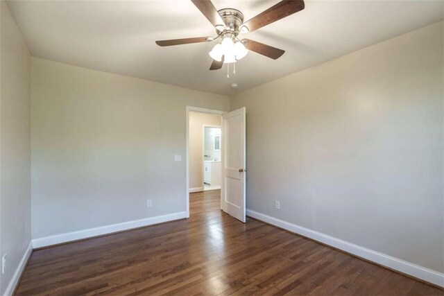 empty room featuring ceiling fan and dark wood-type flooring