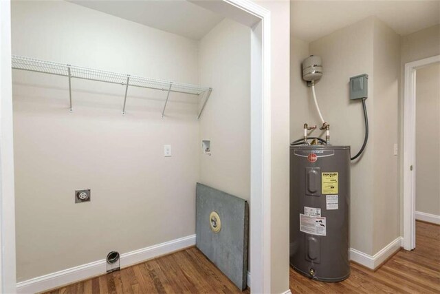 clothes washing area with washer hookup, hookup for an electric dryer, electric water heater, and hardwood / wood-style flooring