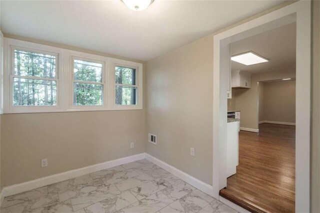 spare room featuring light hardwood / wood-style flooring