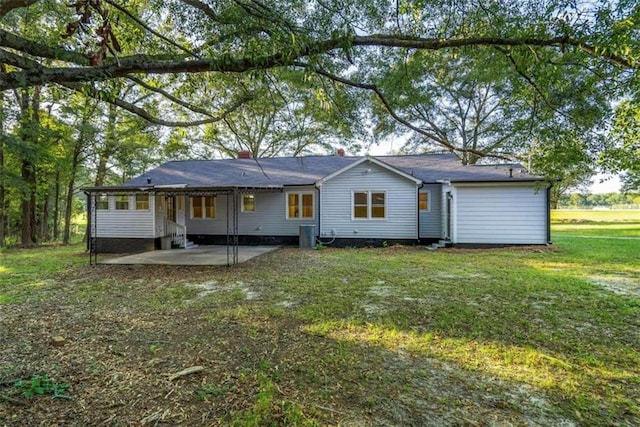 rear view of house with a lawn and a patio area