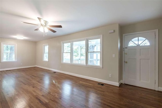 foyer entrance with ceiling fan, plenty of natural light, and dark hardwood / wood-style floors