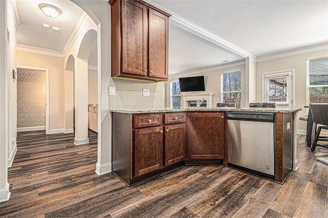 kitchen featuring plenty of natural light, arched walkways, dark wood finished floors, and dishwasher