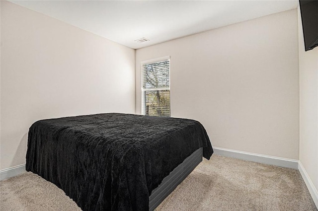 bedroom with visible vents, baseboards, and light colored carpet