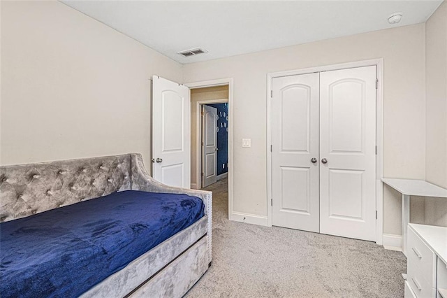 bedroom with carpet floors, a closet, visible vents, and baseboards