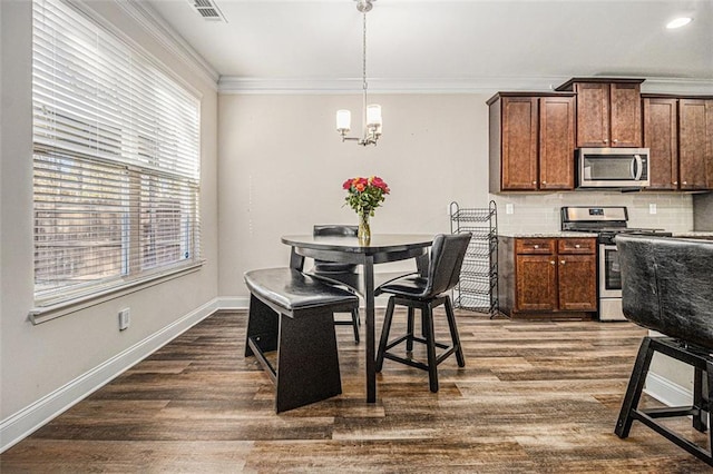 dining area featuring a chandelier, visible vents, baseboards, dark wood finished floors, and crown molding