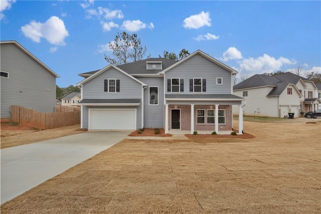 view of property featuring a garage and covered porch