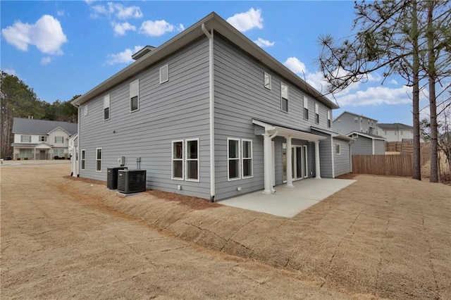 back of house with central AC unit and a patio