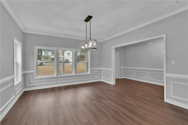 unfurnished dining area with dark hardwood / wood-style flooring, crown molding, and a chandelier