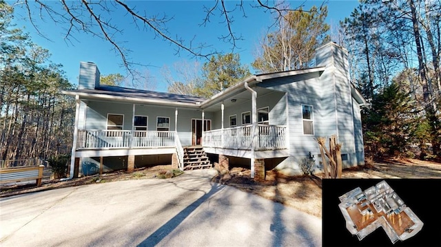 rear view of property featuring covered porch