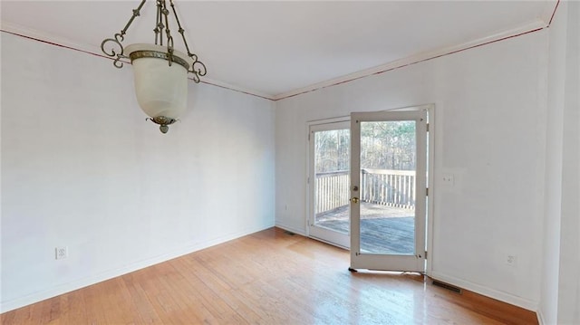 interior space with hardwood / wood-style floors and crown molding