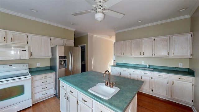 kitchen with sink, white appliances, wood-type flooring, white cabinets, and a center island with sink