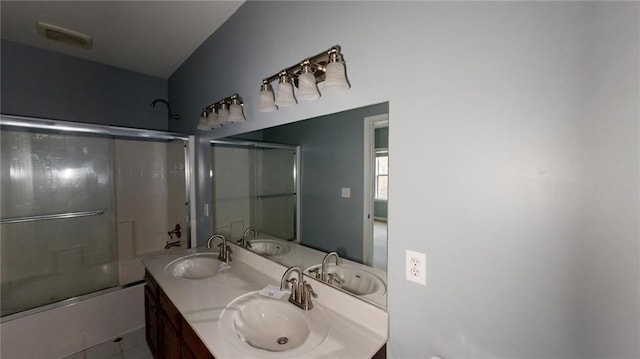 bathroom with vanity and shower / bath combination with glass door