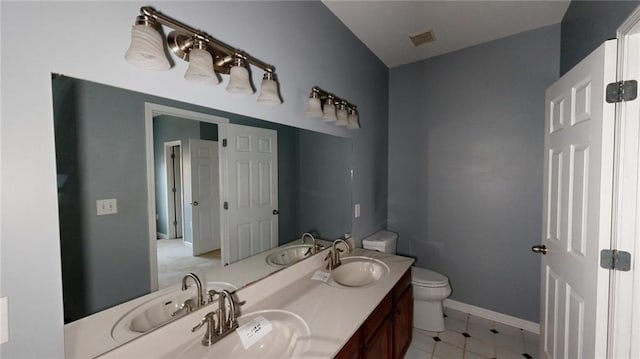 bathroom featuring vanity, toilet, and tile patterned flooring