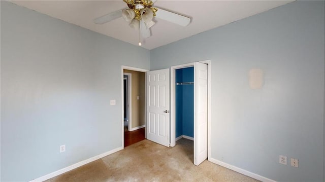 unfurnished bedroom with light colored carpet, ceiling fan, and a closet